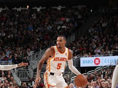 MILWAUKEE, WI - DECEMBER 2: Dejounte Murray #5 of the Atlanta Hawks dribbles the ball during the game against the Milwaukee Bucks on December 2, 2023 at the Fiserv Forum Center in Milwaukee, Wisconsin. NOTE TO USER: User expressly acknowledges and agrees that, by downloading and or using this Photograph, user is consenting to the terms and conditions of the Getty Images License Agreement. Mandatory Copyright Notice: Copyright 2023 NBAE (Photo by Gary Dineen/NBAE via Getty Images).