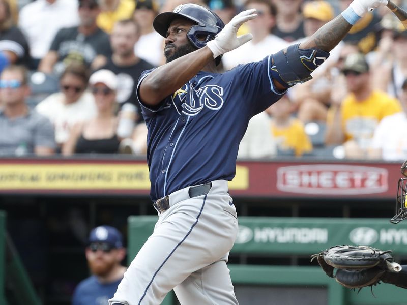 Jun 23, 2024; Pittsburgh, Pennsylvania, USA;  Tampa Bay Rays left fielder Randy Arozarena (56) drives in a run with a sacrifice fly against the Pittsburgh Pirates during the eighth inning at PNC Park. Mandatory Credit: Charles LeClaire-USA TODAY Sports