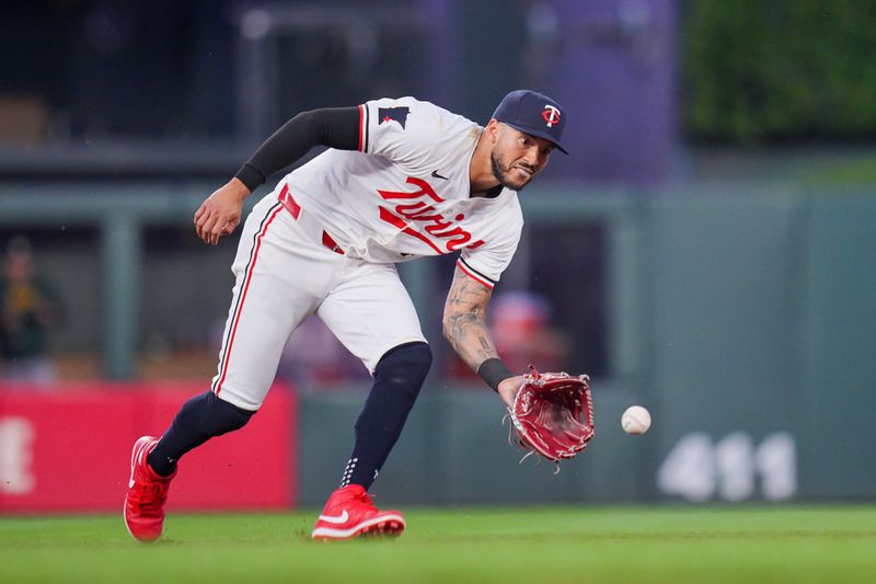 Jun 13, 2024; Minneapolis, Minnesota, USA; Minnesota Twins shortstop Carlos Correa (4) fields a ground ball against the Oakland Athletics in the ninth inning at Target Field. Mandatory Credit: Brad Rempel-USA TODAY Sports