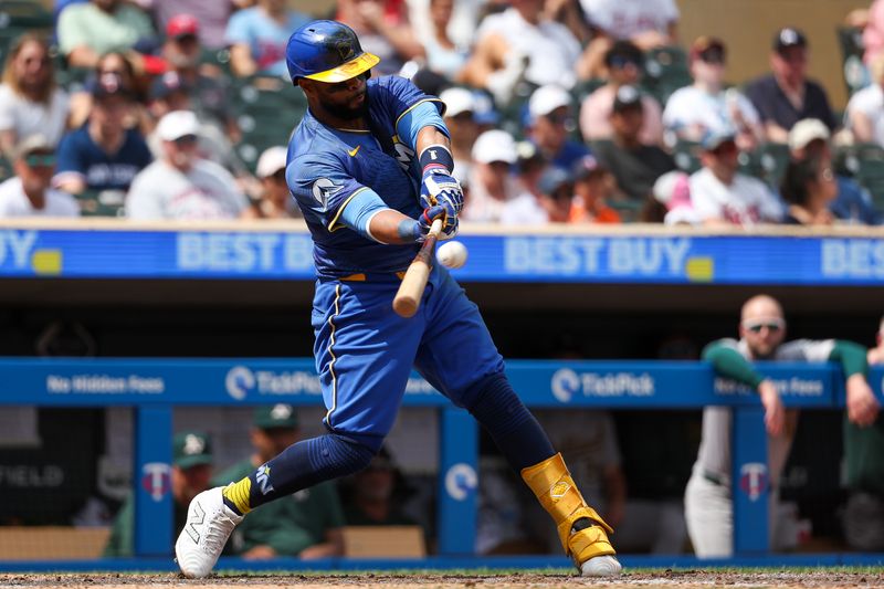 Jun 16, 2024; Minneapolis, Minnesota, USA; Minnesota Twins first baseman Carlos Santana (30) hits a two-run home run against the Oakland Athletics during the seventh inning of game one of a double header at Target Field. Mandatory Credit: Matt Krohn-USA TODAY Sports