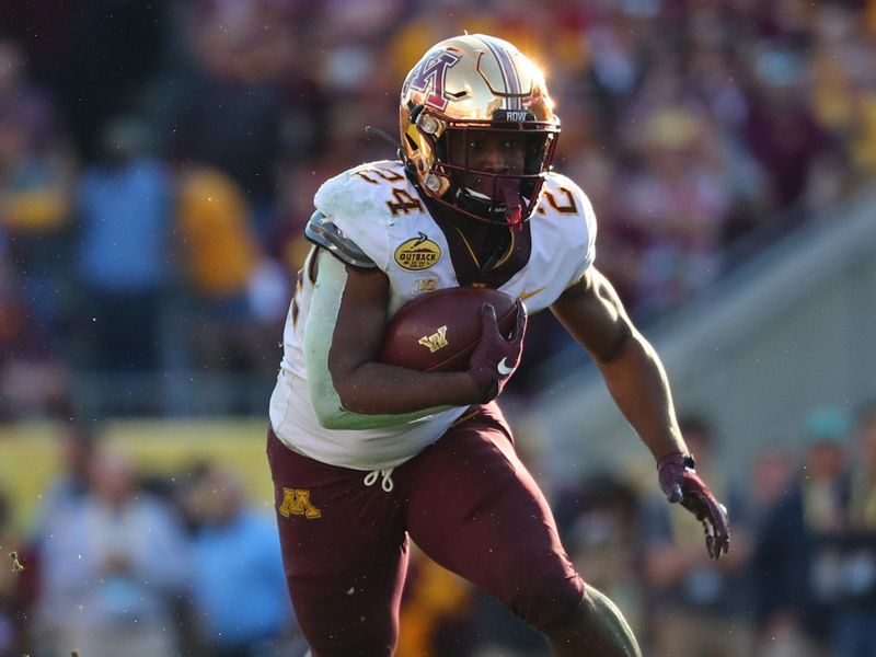 Jan 1, 2020; Tampa, Florida, USA; Minnesota Golden Gophers running back Mohamed Ibrahim (24) runs with the ball against the Auburn Tigers during the second half at Raymond James Stadium. Mandatory Credit: Kim Klement-USA TODAY Sports