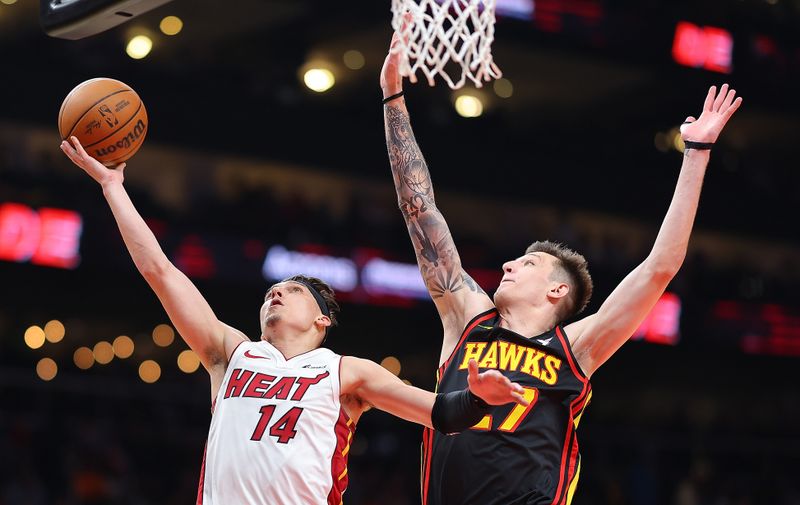 ATLANTA, GEORGIA - APRIL 09:  Tyler Herro #14 of the Miami Heat attacks the basket against Vit Krejci #27 of the Atlanta Hawks during the second quarter at State Farm Arena on April 09, 2024 in Atlanta, Georgia.  NOTE TO USER: User expressly acknowledges and agrees that, by downloading and/or using this photograph, user is consenting to the terms and conditions of the Getty Images License Agreement.  (Photo by Kevin C. Cox/Getty Images)