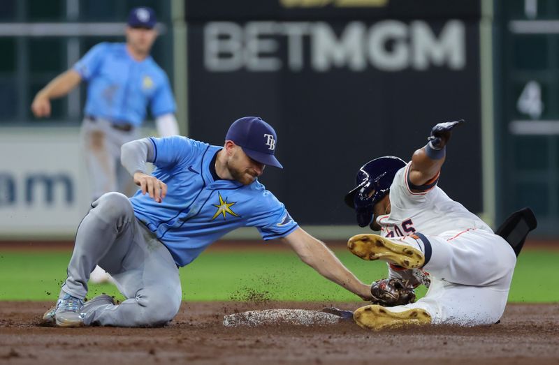 Aug 3, 2024; Houston, Texas, USA; Houston Astros center fielder Pedro Leon (4) is tagged out by Tampa Bay Rays second baseman Brandon Lowe (8) at second baseman in the third inning at Minute Maid Park. Mandatory Credit: Thomas Shea-USA TODAY Sports