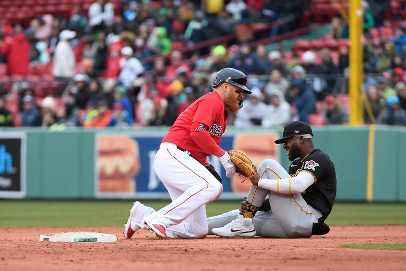 Apr 5, 2023; Boston, Massachusetts, USA; Pittsburgh Pirates second baseman Rodolfo Castro (14) grabs his ankle after a collision with Boston Red Sox first baseman Justin Turner (2) at second base during the ninth inning a at Fenway Park. Mandatory Credit: Eric Canha-USA TODAY Sports