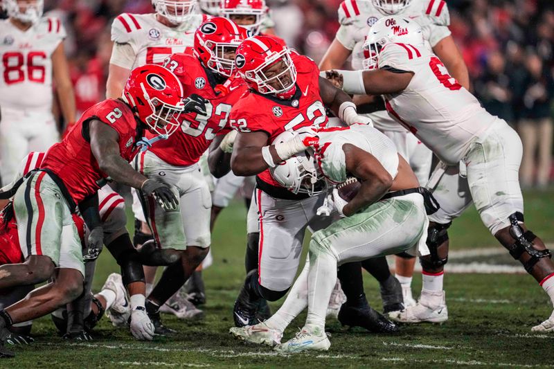 Nov 11, 2023; Athens, Georgia, USA; A Georgia Bulldogs defensive lineman Christen Miller (52) tackles Mississippi Rebels running back Quinshon Judkins (4) during the second half at Sanford Stadium. Mandatory Credit: Dale Zanine-USA TODAY Sports