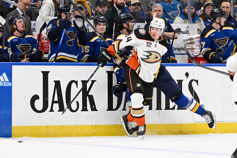 Mar 17, 2024; St. Louis, Missouri, USA; Anaheim Ducks defenseman Pavel Mintyukov (34) battles St. Louis Blues center Oskar Sundqvist (70) during the second period at Enterprise Center. Mandatory Credit: Jeff Le-USA TODAY Sports