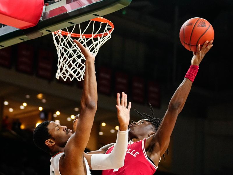 Feb 11, 2023; Coral Gables, Florida, USA; Miami (Fl) Hurricanes forward A.J. Casey (0) fouls Louisville Cardinals guard Mike James (1) during the first half at Watsco Center. Mandatory Credit: Rich Storry-USA TODAY Sports