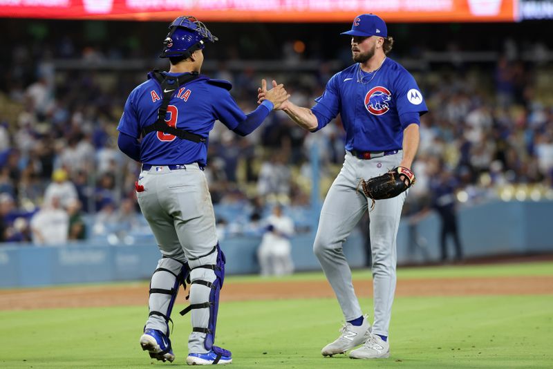 Sep 10, 2024; Los Angeles, California, USA;  Chicago Cubs relief pitcher Porter Hodge (37) and catcher Miguel Amaya (9) celebrate a victory after defeating the Los Angeles Dodgers at Dodger Stadium. Mandatory Credit: Kiyoshi Mio-Imagn Images