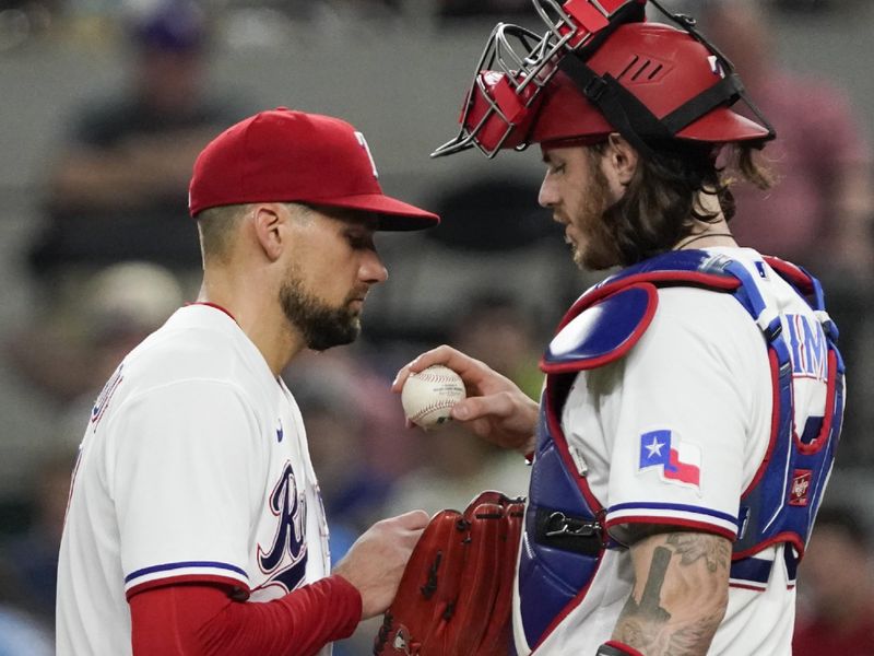 May 17, 2023; Arlington, Texas, USA; Texas Rangers starting pitcher Nathan Eovaldi (17) is visited on the mound by catcher Jonah Heim (28) during the seventh inning against the Atlanta Braves at Globe Life Field. Mandatory Credit: Raymond Carlin III-USA TODAY Sports