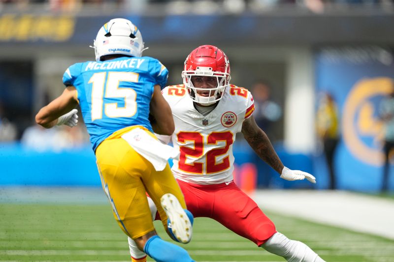 Los Angeles Chargers wide receiver Ladd McConkey (15) runs with the ball as Kansas City Chiefs cornerback Trent McDuffie (22) defends during the first half of an NFL football game Sunday, Sept. 29, 2024, in Inglewood, Calif. (AP Photo/Ashley Landis)