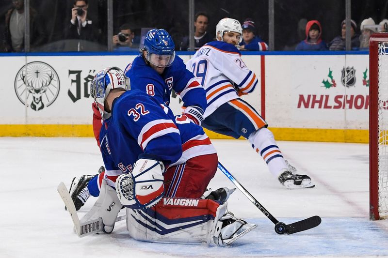 Dec 22, 2023; New York, New York, USA;  New York Rangers defenseman Jacob Trouba (8) helps  New York Rangers goaltender Jonathan Quick (32) defend the goal against Edmonton Oilers during the third period at Madison Square Garden. Mandatory Credit: Dennis Schneidler-USA TODAY Sports