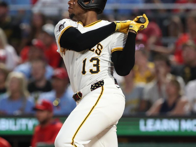 Jun 30, 2025; Pittsburgh, Pennsylvania, USA;  Pittsburgh Pirates third baseman Ke'Bryan Hayes (13) hits a two-run single against the St. Louis Cardinals during the fifth inning at PNC Park. Mandatory Credit: Charles LeClaire-Imagn Images