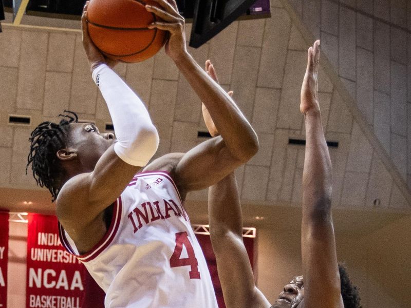 Jan 12, 2024; Bloomington, Indiana, USA; Indiana Hoosiers forward Anthony Walker (4) shoots the ball while Minnesota Golden Gophers forward Joshua Ola-Joseph (1) defends in the first half at Simon Skjodt Assembly Hall. Mandatory Credit: Trevor Ruszkowski-USA TODAY Sports