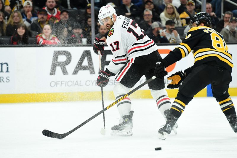 Apr 10, 2025; Boston, Massachusetts, USA; Chicago Blackhawks left wing Nick Foligno (17) makes a backhand pass past Boston Bruins right wing David Pastrnak (88) during the second period at TD Garden. Mandatory Credit: Bob DeChiara-Imagn Images
