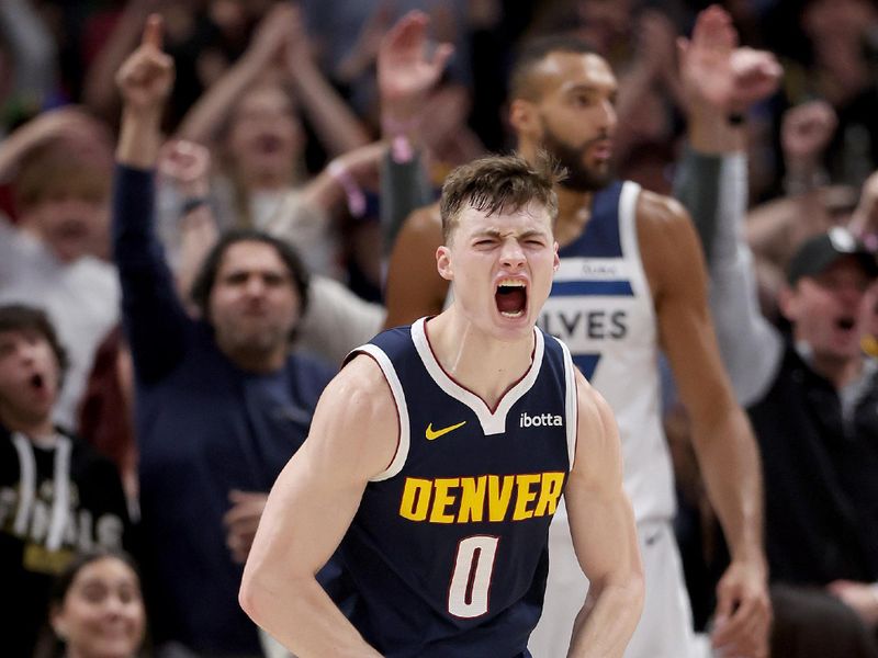 DENVER, COLORADO - APRIL 10: Christian Braun #0 of the Denver Nuggets celebrates after dunking on Rudy Gobert #27 of the Minnesota Timberwolves during the fourth quarter at Ball Arena on April 10, 2024 in Denver, Colorado. NOTE TO USER: User expressly acknowledges and agrees that, by downloading and or using this photograph, User is consenting to the terms and conditions of the Getty Images License Agreement.  (Photo by Matthew Stockman/Getty Images)