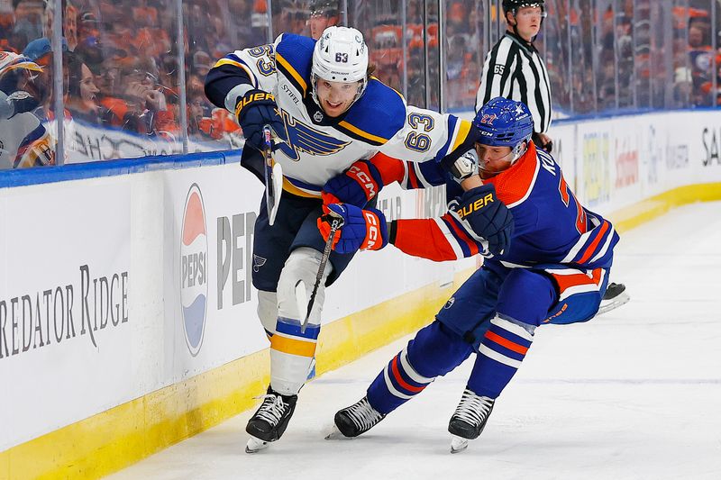 Feb 28, 2024; Edmonton, Alberta, CAN; St. Louis Blues forward Jake Neighbours (63) and Edmonton Oilers defensemen Brett Kulak (27) battle for a loose puck during the second period at Rogers Place. Mandatory Credit: Perry Nelson-USA TODAY Sports