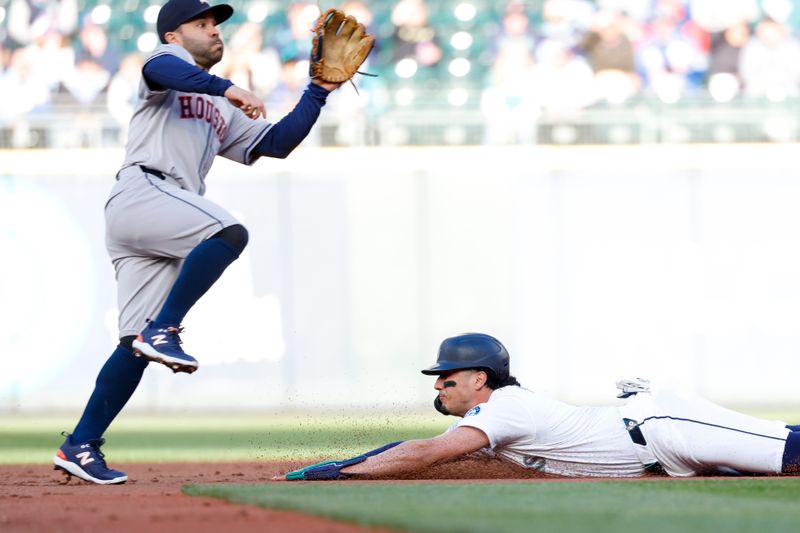 May 28, 2024; Seattle, Washington, USA; Seattle Mariners third baseman Josh Rojas (4) steals second base against Houston Astros second baseman Jose Altuve (27) during the first inning at T-Mobile Park. Mandatory Credit: Joe Nicholson-USA TODAY Sports