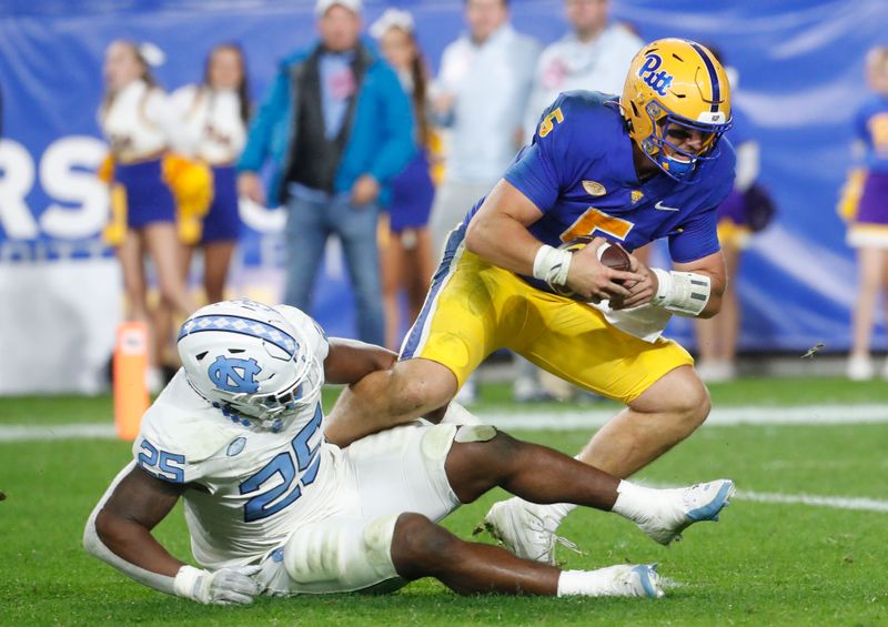 Sep 23, 2023; Pittsburgh, Pennsylvania, USA; North Carolina Tar Heels linebacker Kaimon Rucker (25) sacks Pittsburgh Panthers quarterback Phil Jurkovec (5) during the second quarter at Acrisure Stadium. Mandatory Credit: Charles LeClaire-USA TODAY Sports