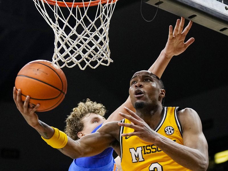 Jan 20, 2024; Columbia, Missouri, USA; Missouri Tigers guard Tamar Bates (2) shoots against Florida Gators center Micah Handlogten (3) during the first half at Mizzou Arena. Mandatory Credit: Jay Biggerstaff-USA TODAY Sports