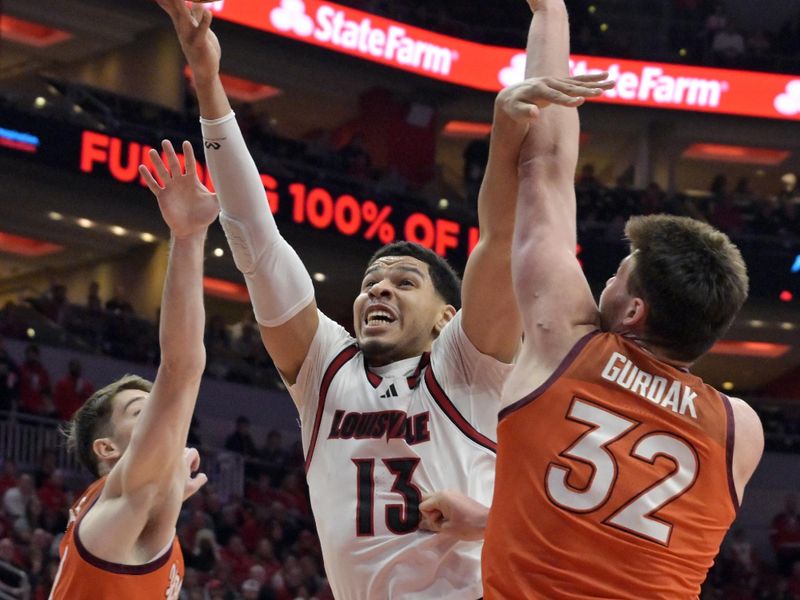 Jan 24, 2026; Louisville, Kentucky, USA;  Louisville Cardinals forward Sananda Fru (13) shoots against Virginia Tech Hokies center Christian Gurdak (32) and Virginia Tech Hokies guard Neoklis Avdalas (17) during the first half at KFC Yum! Center. Mandatory Credit: Jamie Rhodes-Imagn Images