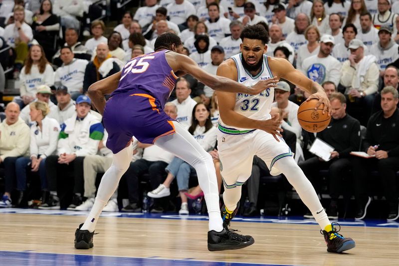 MINNEAPOLIS, MINNESOTA - APRIL 20: Karl-Anthony Towns #32 of the Minnesota Timberwolves dribbles the ball against Kevin Durant #35 of the Phoenix Suns during the first quarter in game one of the Western Conference First Round Playoffs at Target Center on April 20, 2024 in Minneapolis, Minnesota. NOTE TO USER: User expressly acknowledges and agrees that, by downloading and or using this photograph, User is consenting to the terms and conditions of the Getty Images License Agreement. (Photo by Patrick McDermott/Getty Images)