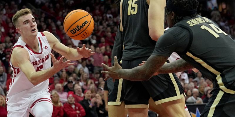 Mar. 2, 2023; Milwaukee, Wisconsin, USA; Wisconsin Badgers forward Tyler Wahl (5) and Purdue Boilermakers guard David Jenkins Jr. (14) battle for a rebound during the second half of their game at Kohl Center. Mandatory Credit: Mark Hoffman-USA TODAY Sports
