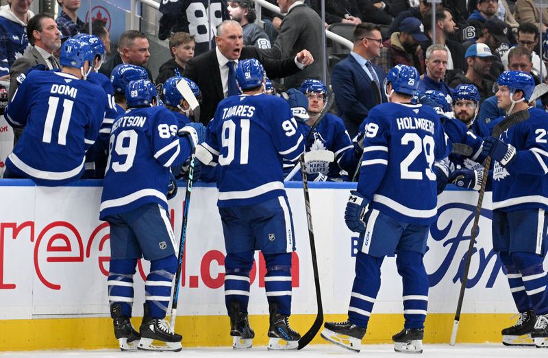 Oct 16, 2024; Toronto, Ontario, CAN; Toronto Maple Leafs head coach Craig Berube speaks to his players after calling a time out in the third period against the Los Angeles Kings at Scotiabank Arena. Mandatory Credit: Dan Hamilton-Imagn Images