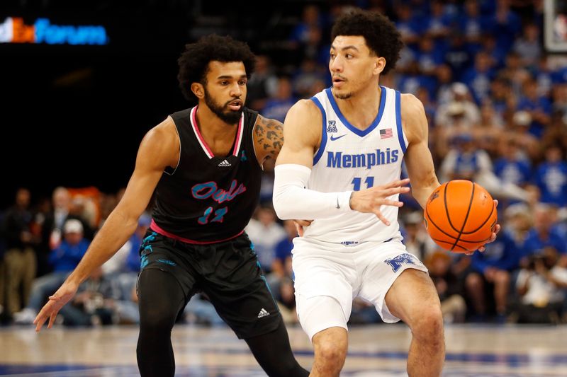 Feb 25, 2024; Memphis, Tennessee, USA; Memphis Tigers guard Jahvon Quinerly (11) dribbles as Florida Atlantic Owls guard Jalen Gaffney (12) defends during the first half at FedExForum. Mandatory Credit: Petre Thomas-USA TODAY Sports