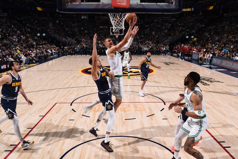 DENVER, CO - JANUARY 7: Kristaps Porzingis #8 of the Boston Celtics drives to the basket during the game against the Denver Nuggets on January 7, 2025 at Ball Arena in Denver, Colorado. NOTE TO USER: User expressly acknowledges and agrees that, by downloading and/or using this Photograph, user is consenting to the terms and conditions of the Getty Images License Agreement. Mandatory Copyright Notice: Copyright 2025 NBAE (Photo by Garrett Ellwood/NBAE via Getty Images)