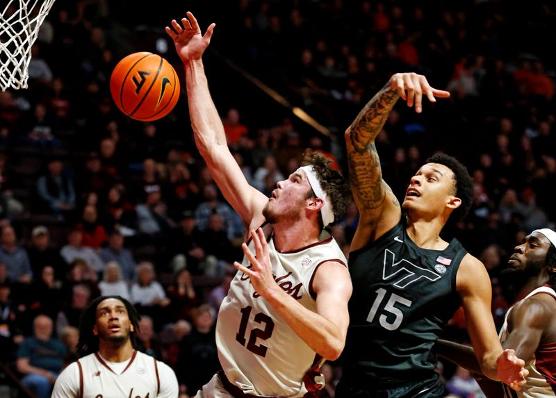 Jan 23, 2024; Blacksburg, Virginia, USA; Boston College Eagles forward Quinten Post (12) and Virginia Tech Hokies center Lynn Kidd (15) go for a rebound during the second half at Cassell Coliseum. Mandatory Credit: Peter Casey-USA TODAY Sports