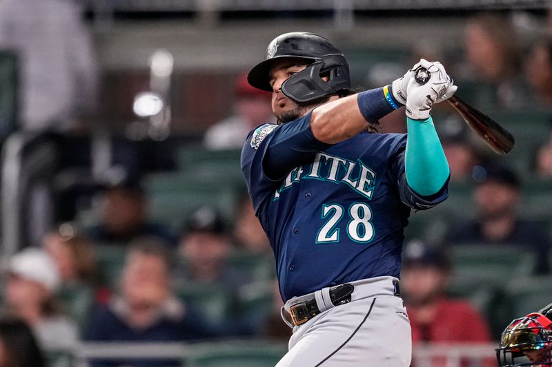 May 19, 2023; Cumberland, Georgia, USA; Seattle Mariners third baseman Eugenio Suarez (28) singles to drive in two runs against the Atlanta Braves during the seventh inning at Truist Park. Mandatory Credit: Dale Zanine-USA TODAY Sports