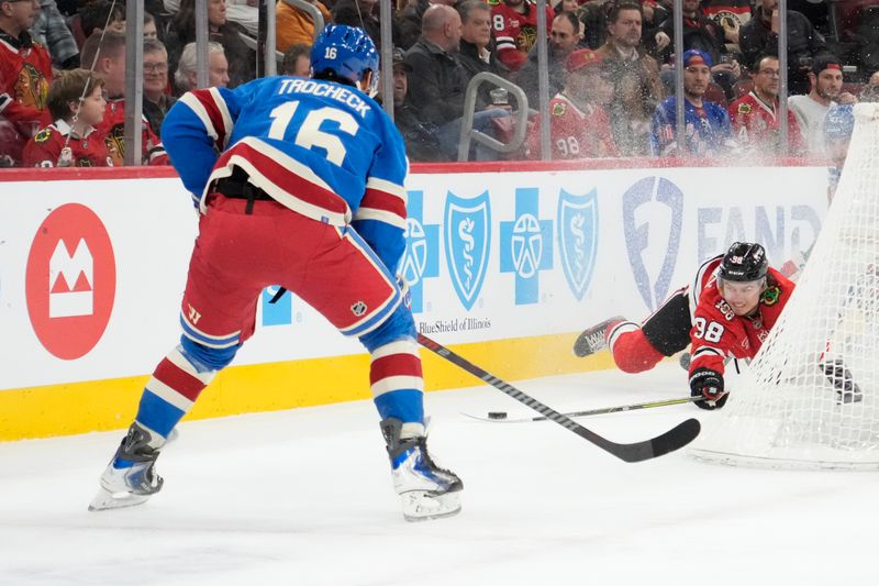 Dec 10, 2025; Chicago, Illinois, USA; Chicago Blackhawks center Connor Bedard (98) and New York Rangers center Vincent Trocheck (16) go for the puck during the first period at United Center. Mandatory Credit: David Banks-Imagn Images