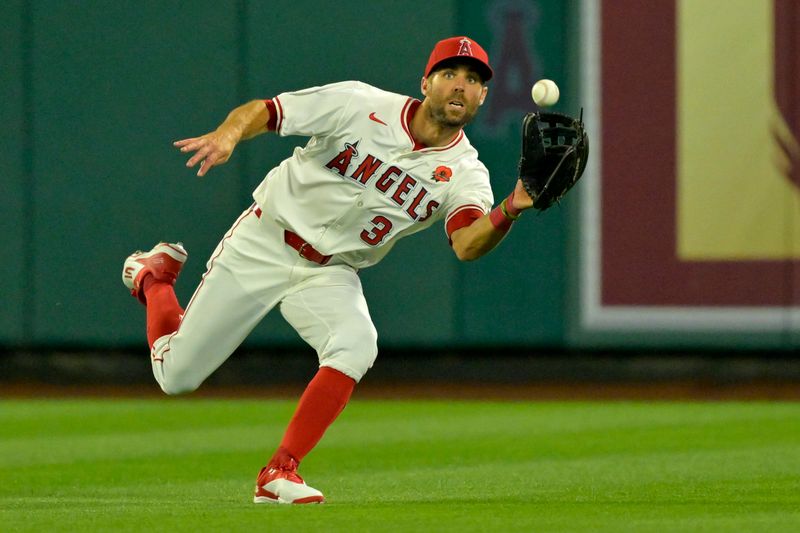 May 26, 2025; Anaheim, California, USA;  Los Angeles Angels center fielder Chris Taylor (33) makes a running catch off a ball hit by New York Yankees third baseman Oswald Peraza (18) in the eighth inning at Angel Stadium. Mandatory Credit: Jayne Kamin-Oncea-Imagn Images