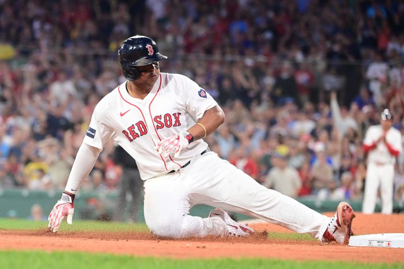 Jul 28, 2024; Boston, Massachusetts, USA; Boston Red Sox third baseman Rafael Devers (11) slides into third base during the fourth inning against the New York Yankees at Fenway Park. Mandatory Credit: Eric Canha-USA TODAY Sports