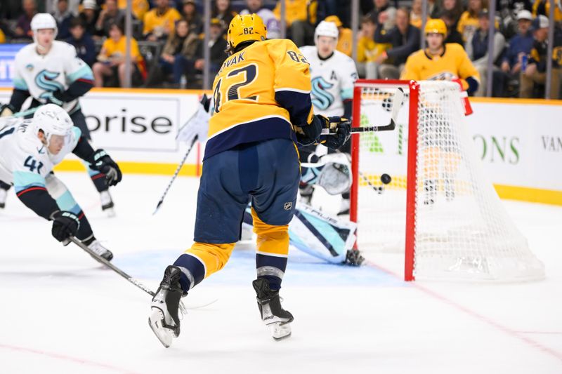 Oct 15, 2024; Nashville, Tennessee, USA;  Nashville Predators center Tommy Novak (82) scores past Seattle Kraken goaltender Joey Daccord (35) during the first period at Bridgestone Arena. Mandatory Credit: Steve Roberts-Imagn Images