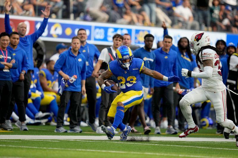 Los Angeles Rams running back Kyren Williams (23) is chased by Arizona Cardinals safety Andre Chachere (36) during the second half of an NFL football game Sunday, Oct. 15, 2023, in Inglewood, Calif. (AP Photo/Ashley Landis)