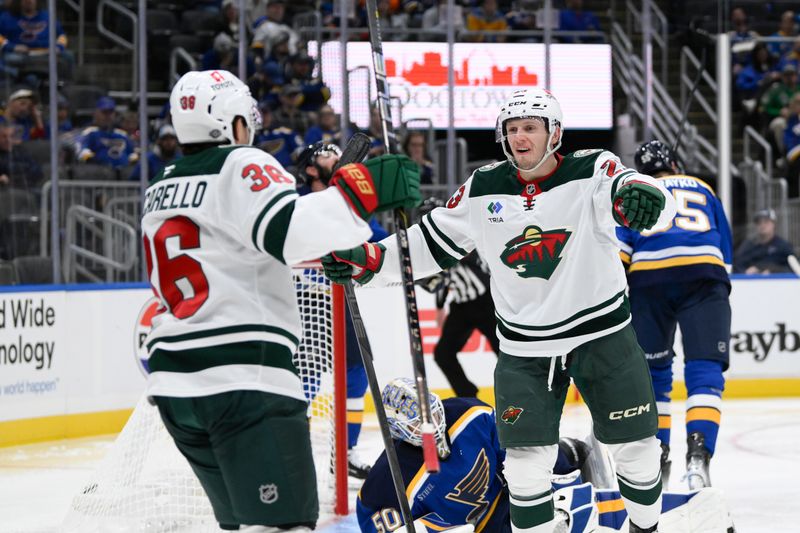 Oct 15, 2024; St. Louis, Missouri, USA; Minnesota Wild center Marco Rossi (23) celebrates with right wing Mats Zuccarello (36) after scoring a goal against the St. Louis Blues during the third period at Enterprise Center. Mandatory Credit: Jeff Le-Imagn Images