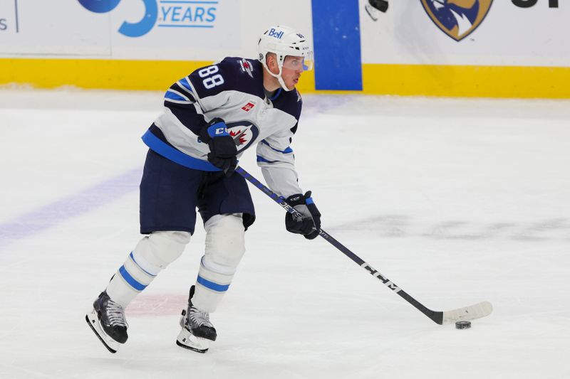 Nov 24, 2023; Sunrise, Florida, USA; Winnipeg Jets defenseman Nate Schmidt (88) moves the puck against the Florida Panthers during the third period at Amerant Bank Arena. Mandatory Credit: Sam Navarro-USA TODAY Sports