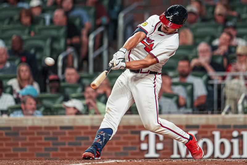 May 13, 2025; Cumberland, Georgia, USA; Atlanta Braves catcher Drake Baldwin (30) hits a double against the Washington Nationals during the eighth inning at Truist Park. Mandatory Credit: Dale Zanine-Imagn Images