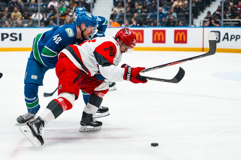 Mar 4, 2026; Vancouver, British Columbia, CAN; Vancouver Canucks forward Elias Pettersson (40) battles with Carolina Hurricanes forward Seth Jarvis (24) in the second at Rogers Arena. Mandatory Credit: Bob Frid-Imagn Images