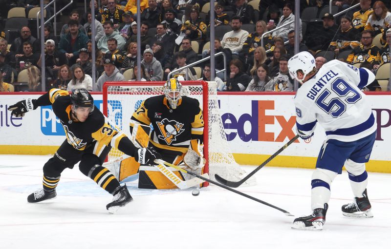 Jan 13, 2026; Pittsburgh, Pennsylvania, USA;  Pittsburgh Penguins defenseman Jack St. Ivany (3) and goaltender Arturs Silovs (37) defend a shot by Tampa Bay Lightning center Jake Guentzel (59) during the second period at PPG Paints Arena. Mandatory Credit: Charles LeClaire-Imagn Images