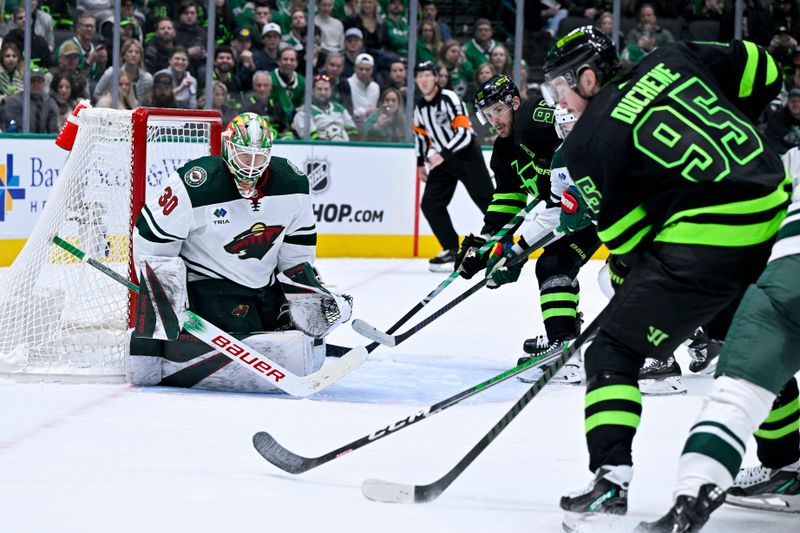 Jan 10, 2024; Dallas, Texas, USA; Minnesota Wild goaltender Jesper Wallstedt (30) faces a shot from Dallas Stars center Matt Duchene (95) and center Tyler Seguin (91) during the second period at the American Airlines Center. Mandatory Credit: Jerome Miron-USA TODAY Sports