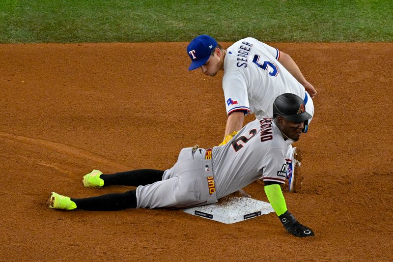 Oct 28, 2023; Arlington, Texas, USA; Arizona Diamondbacks shortstop Geraldo Perdomo (2) steals second base as Texas Rangers shortstop Corey Seager (5) looks back during the fifth inning in game two of the 2023 World Series at Globe Life Field. Mandatory Credit: Jerome Miron-USA TODAY Sports