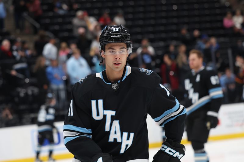 Oct 30, 2024; Salt Lake City, Utah, USA; Utah Hockey Club right wing Dylan Guenther (11) warms up before a game against the before the game against the Calgary Flames at Delta Center. Mandatory Credit: Rob Gray-Imagn Images