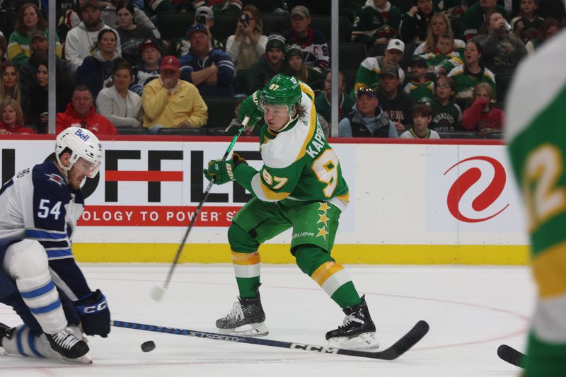 Apr 6, 2024; Saint Paul, Minnesota, USA;  Minnesota Wild left wing Kirill Kaprizov (97)  gets a quick shot off against the Winnipeg Jets during the second period at Xcel Energy Center. Mandatory Credit: Bruce Fedyck-USA TODAY Sports