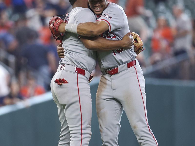 May 22, 2024; Houston, Texas, USA; Los Angeles Angels second baseman Kyren Paris (19) embraces with third baseman Luis Rengifo (2) after the game against the Houston Astros at Minute Maid Park. Mandatory Credit: Troy Taormina-USA TODAY Sports