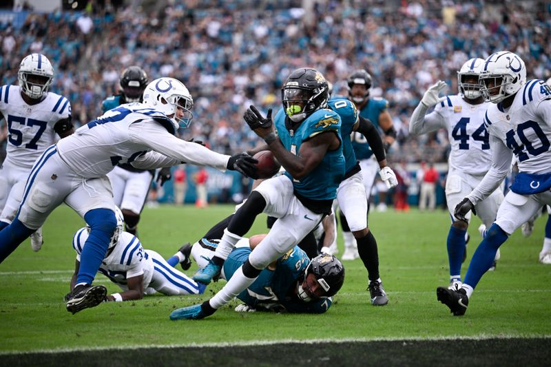 Jacksonville Jaguars running back Tank Bigsby (4) goes in for a touchdown during the second half of an NFL football game against the Indianapolis Colts, Sunday, Oct. 6, 2024, in Jacksonville, Fla. (AP Photo/Phelan M. Ebenhack)