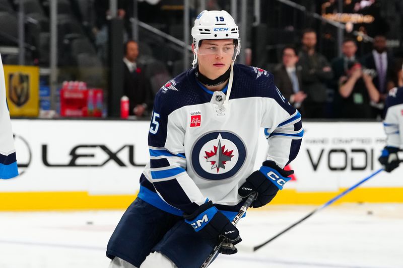 Nov 2, 2023; Las Vegas, Nevada, USA; Winnipeg Jets center Rasmus Kupari (15) wears neck protection as he warms up before a game against the Vegas Golden Knights at T-Mobile Arena. Mandatory Credit: Stephen R. Sylvanie-USA TODAY Sports