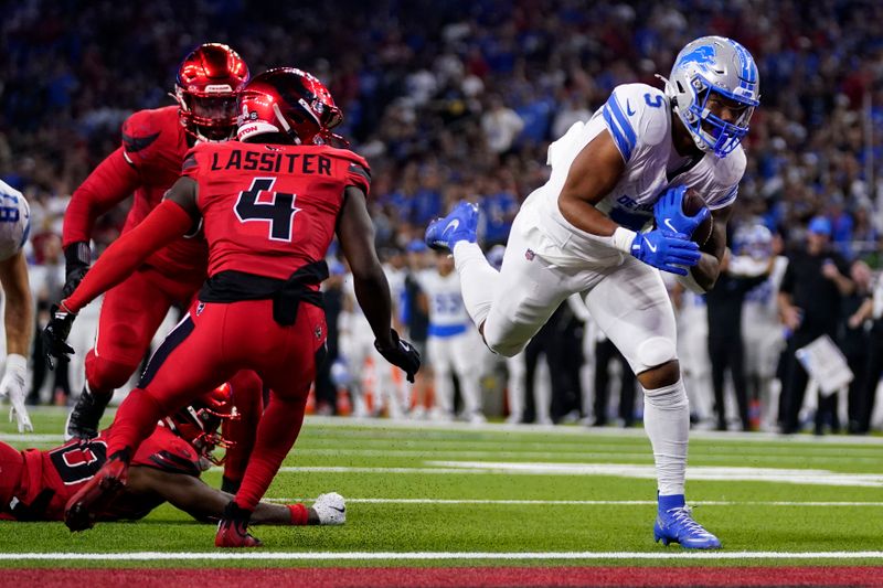 Detroit Lions running back David Montgomery (5) scores on a 3-yard touchdown run in front of Houston Texans cornerback Kamari Lassiter (4) during the second half of an NFL football game, Sunday, Nov. 10, 2024, in Houston. (AP Photo/Eric Christian Smith)