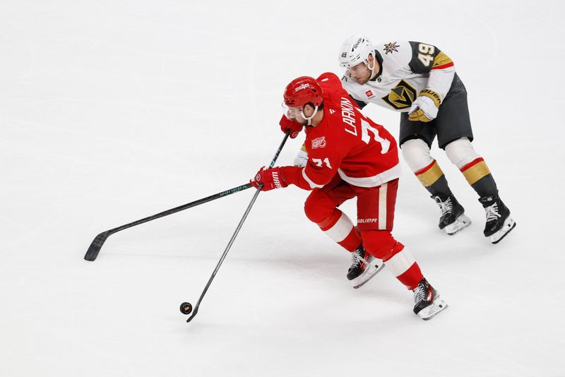 Mar 4, 2026; Detroit, Michigan, USA;  Detroit Red Wings center Dylan Larkin (71) skates with the puck chased by Vegas Golden Knights left wing Ivan Barbashev (49) in the first period at Little Caesars Arena. Mandatory Credit: Rick Osentoski-Imagn Images